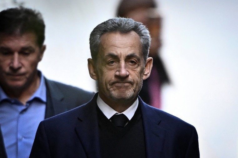 France's former president Nicolas Sarkozy leaves his residence to present himself to La Sante Prison for incarceration on a five-year prison sentence on Oct. 21.