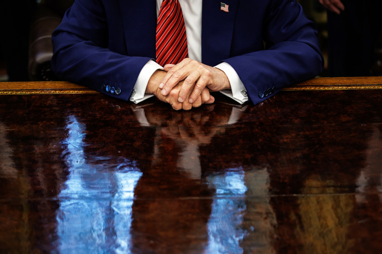 View of Donald Trump's hands on his desk in the Oval Office of the White House.