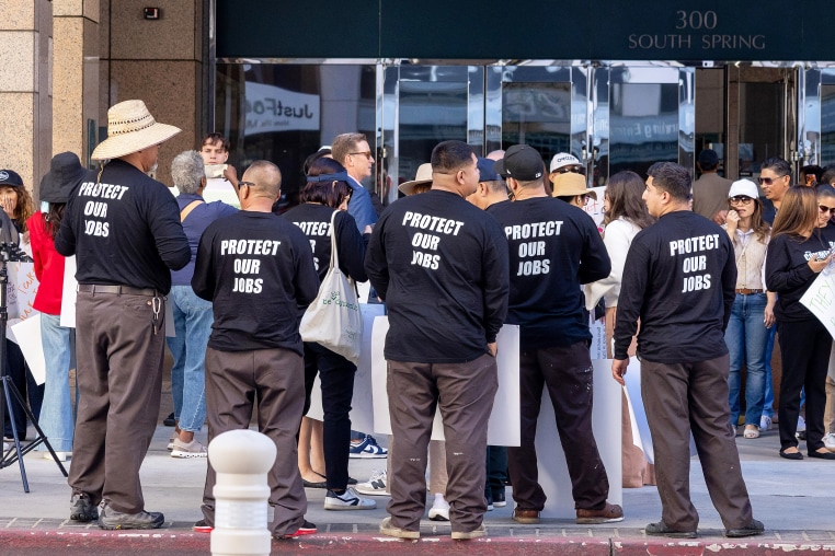Protesters wearing "Protect our Jobs" t-shirts.