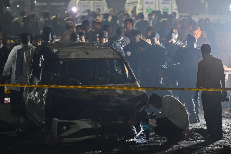 Police and security personnel investigate the scene of an explosion near the Red Fort Metro Station on Nov. 10, 2025 in Delhi, India. 