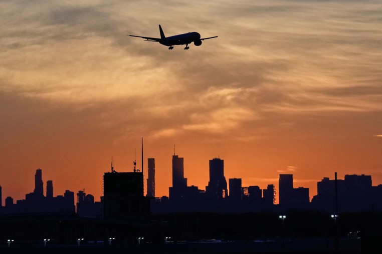 An airplane descends at O'Hare International Airport in Chicago, Wednesday, Nov. 12, 2025. 