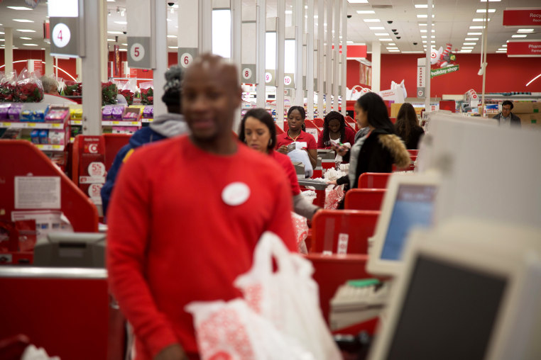 Employees ring customers up at cash registers inside a Target store in Jersey City, N.J.