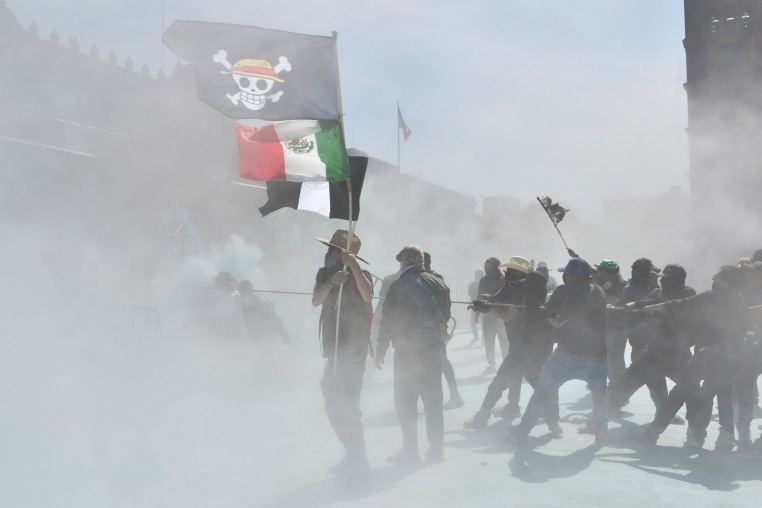 A demonstrator holds a One Piece manga flag and Mexican flag during a protest against the government of Mexican President Claudia Sheinbaum at Zocalo Square in Mexico City on Nov. 15
