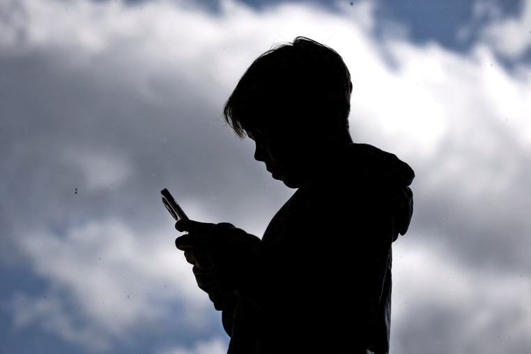 A 14-year-old boy looks at social media on his phone in Gosford, Australia. 