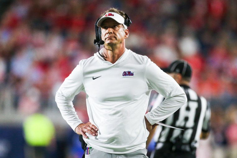Lane Kiffin stands on the football field