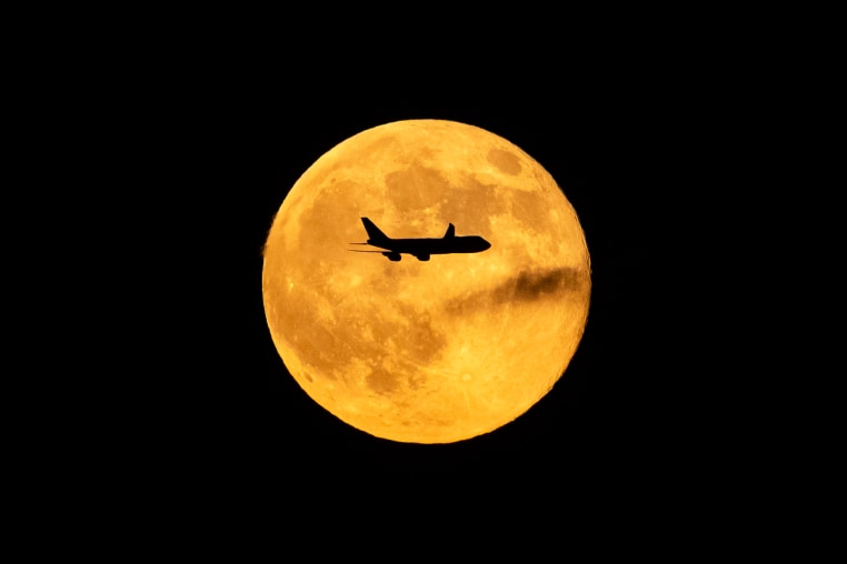 A plane passes in front of the "Beaver supermoon" on Nov. 5, 2025 over Louisville, Ky.