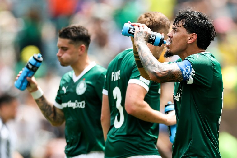 Gustavo Gomez drinks from a Powerade bottle near his teammates