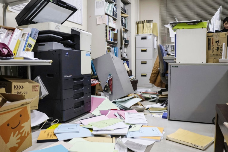 Bookshelves and documents that fell during an earthquake are seen at Kyodo News' Hakodate bureau in Hakodate
