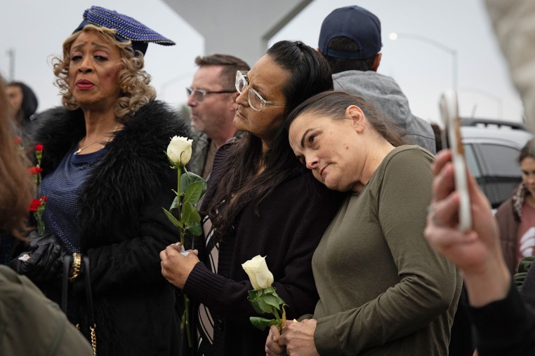People lean on each other at a vigil on Nov. 30, 2025 in Stockton, Calif., for the victims of a shooting at a family party.