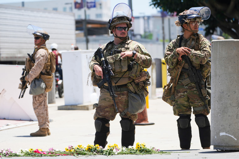 Members of the California National Guard and U.S. Marines guard a federal building