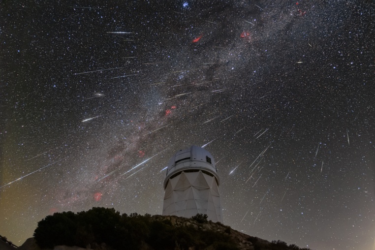 Meteors from the Geminid meteor shower streak across the sky