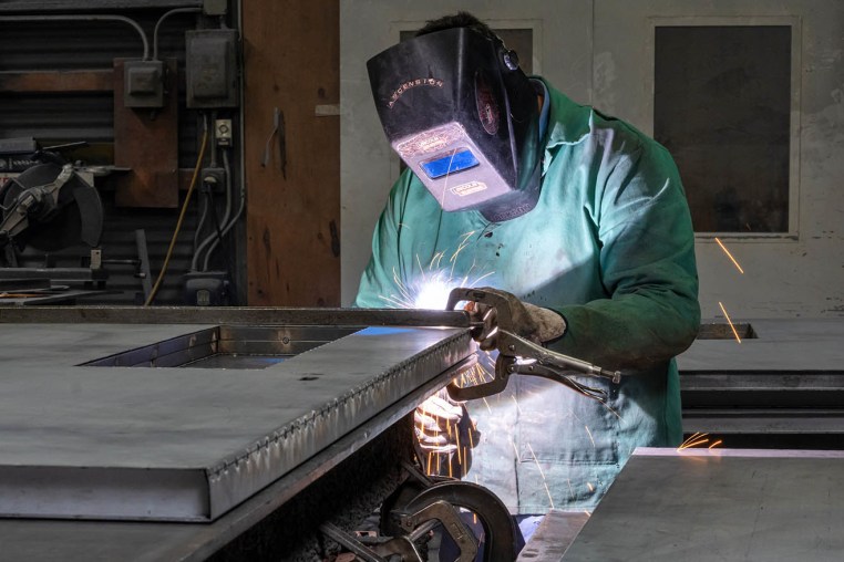 A worker uses an arc welder at the Metal Manufacturing Co. facility in Sacramento, Calif., on May 27, 2025. 