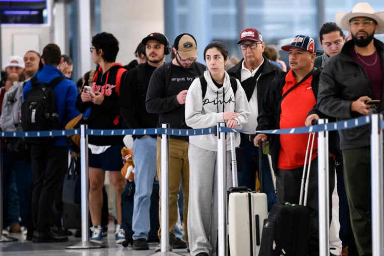 People wait in a security checkpoint line at George Bush Intercontinental Airport in Houston