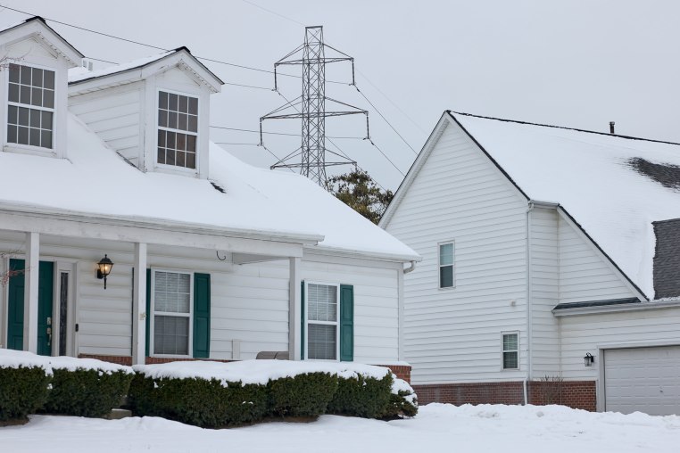 A power transmission line behind homes in a residential neighborhood in Columbus, Ohio, on Tuesday, Dec. 16. 