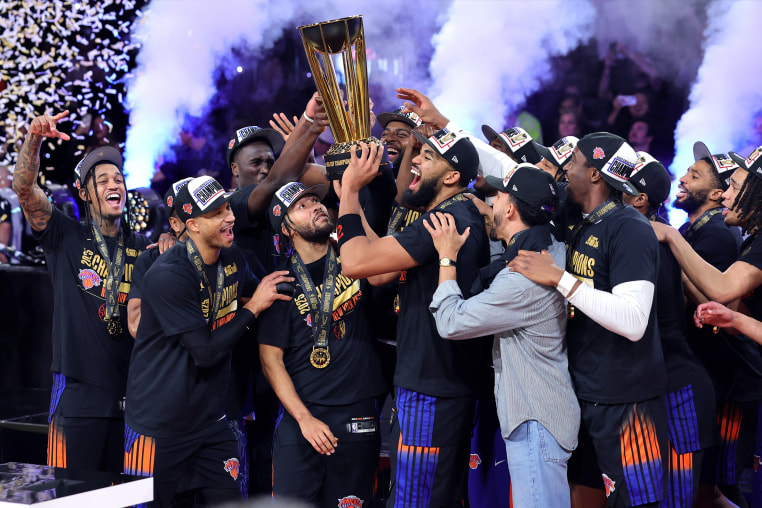 The New York Knicks celebrate with the trophy after the Knicks defeated the San Antonio Spurs 124-113 in the Emirates NBA Cup Championship game at T-Mobile Arena on December 16, 2025 in Las Vegas, Nevada. 