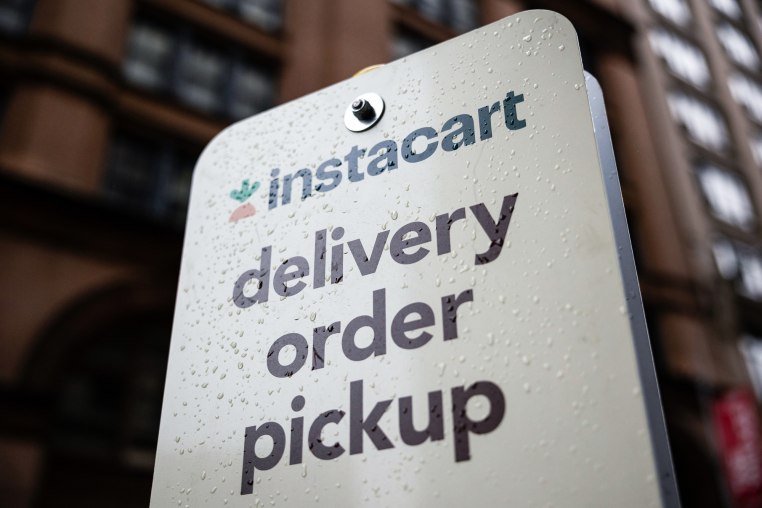 An Instacart sign speckled with raindrops outside