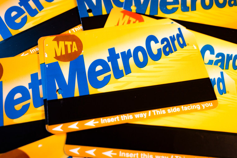 Yellow NYC metrocards stacked on a surface