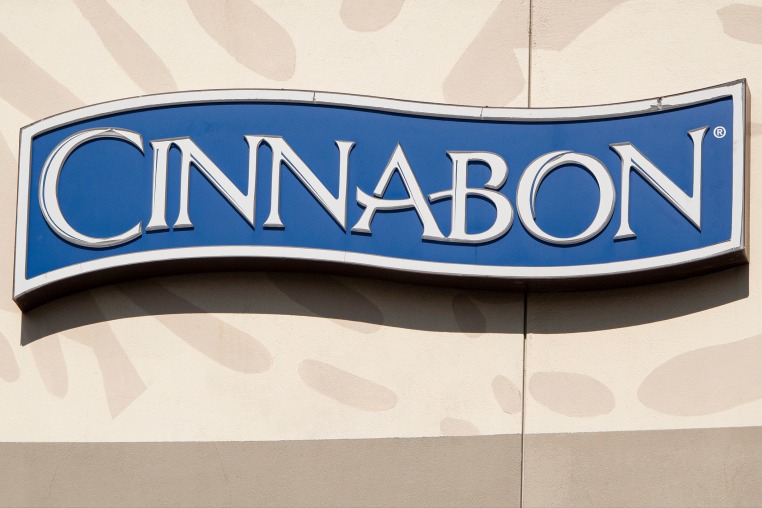The Cinnabon corporate logo is displayed on a sign at their shop.