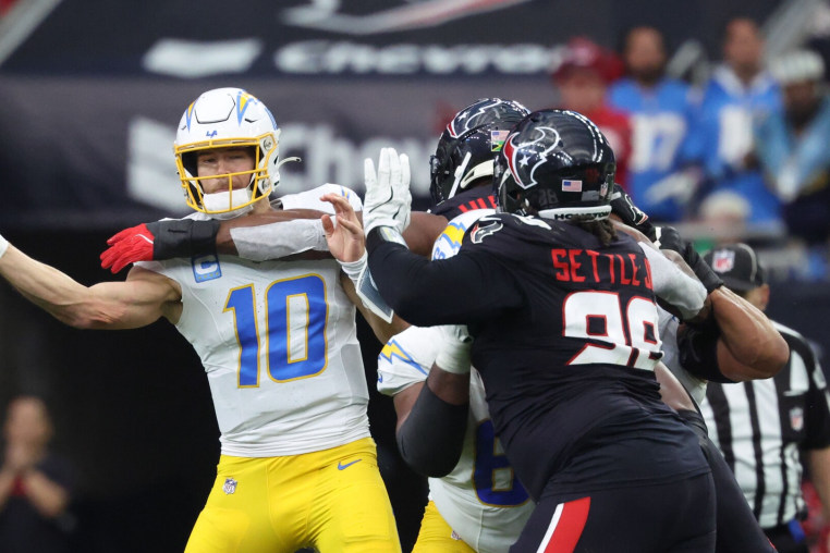 Jan 11, 2025; Houston, Texas, USA; Los Angeles Chargers quarterback Justin Herbert (10) passes during the second quarter against the Houston Texans in an AFC wild card game at NRG Stadium. Mandatory Credit: Troy Taormina-Imagn Images