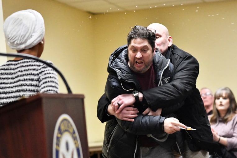 A man is tackled after spraying an unknown substance at US Representative Ilhan Omar