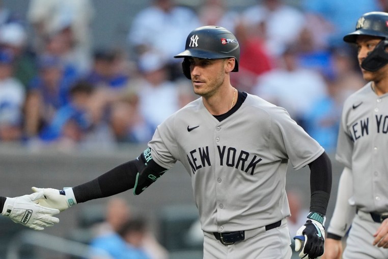 Oct 5, 2025; Toronto, Ontario, CAN; New York Yankees Cody Bellinger (35) is congratulated after hitting a two-run home run in the sixth inning against the Toronto Blue Jays during game two of the ALDS round for the 2025 MLB playoffs at Rogers Centre. Mandatory Credit: John E. Sokolowski-Imagn Images