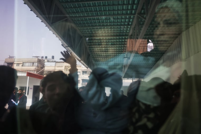 
A Palestinians child waves from the window of a bus evacuating war-wounded and patients, accompanied by relatives, as they ready to leave the Gaza Strip for treatment abroad through the Rafah border crossing between Gaza and Egypt, the day after it was opened by Israel for a limited number of people, in Khan Yunis, in the southern Gaza Strip on February 2, 2026. 