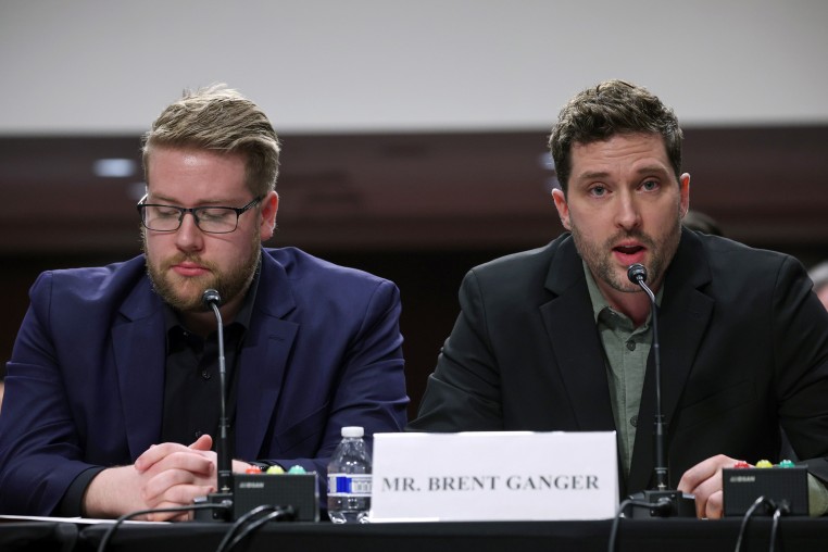 Luke Ganger and Brent Ganger speak during a public forum on violent use of force by Department of Homeland Security (DHS) agents.