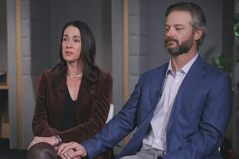 Cici Steward, left, and Will Steward sit next to each other on set, Will holds Cici's hand