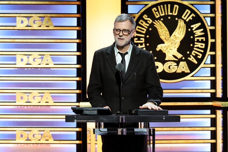 Paul Thomas Anderson speaks at a podium on stage