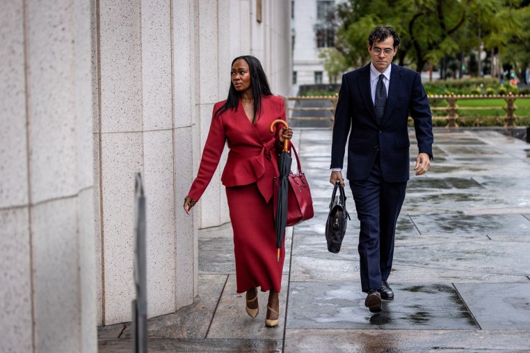 Adam Mosseri, right, walks outside next to a woman