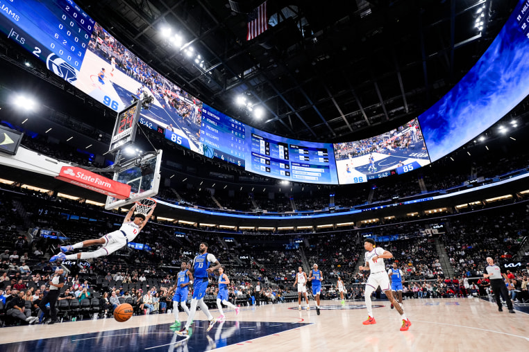 Cam Christie makes a dunk on the basketball court
