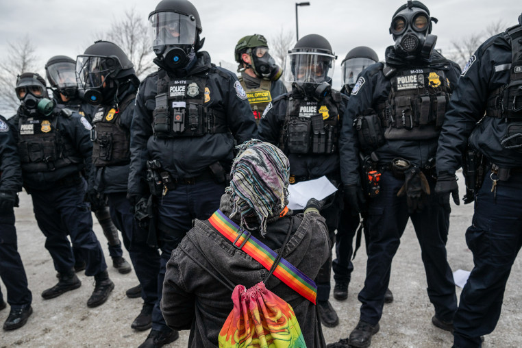 Federal law enforcement officers attempt to disperse demonstrators protesting Immigration and Customs Enforcement (ICE) activity outside the Bishop Henry Whipple Federal Building in St. Paul, MN.