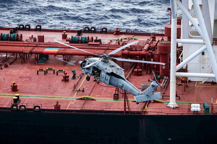 A U.S. military helicopter flies above the Veronica III oil tanker.