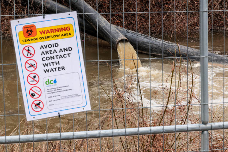 A pipes spills sewage into a body of water