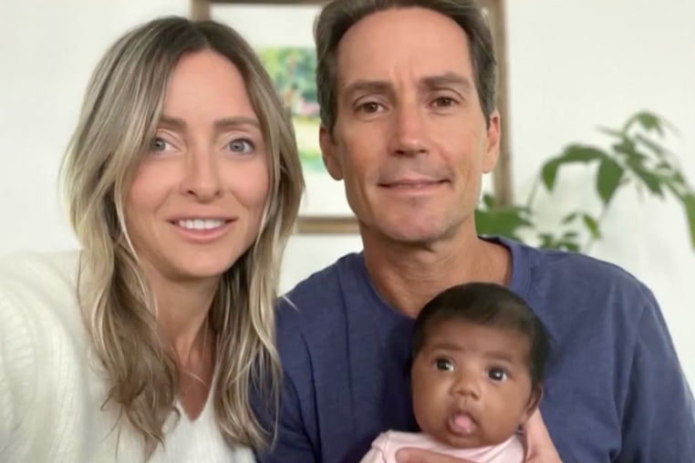 A group photo of Tiffany Score, Steven Mills, and their baby.