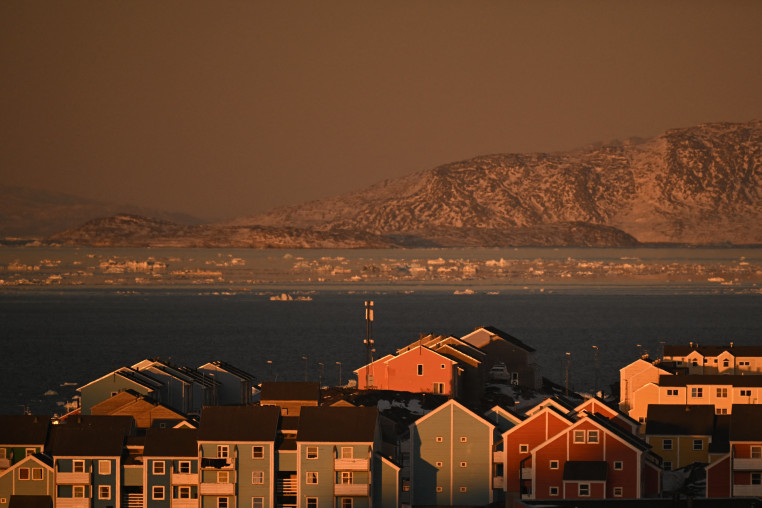 Houses of a residential area and ice floes floating on the sea are seen at the coastline of Nuuk, Greenland on January 29.