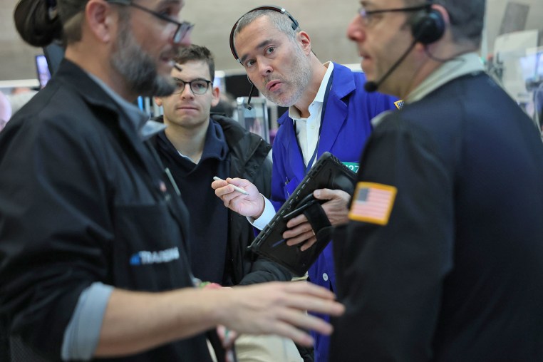 Traders work on the floor of the New York Stock Exchange during morning trading on February 24, 2026.