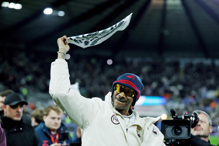 Snoop Dogg waves a rally towel before a soccer match between Swansea City and Preston North End on Feb. 24, 2026 in Swansea, Wales. 