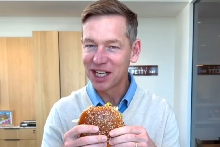 McDonald's CEO Chris Kempczinski tries the fast-food giant's new Big Arch burger.