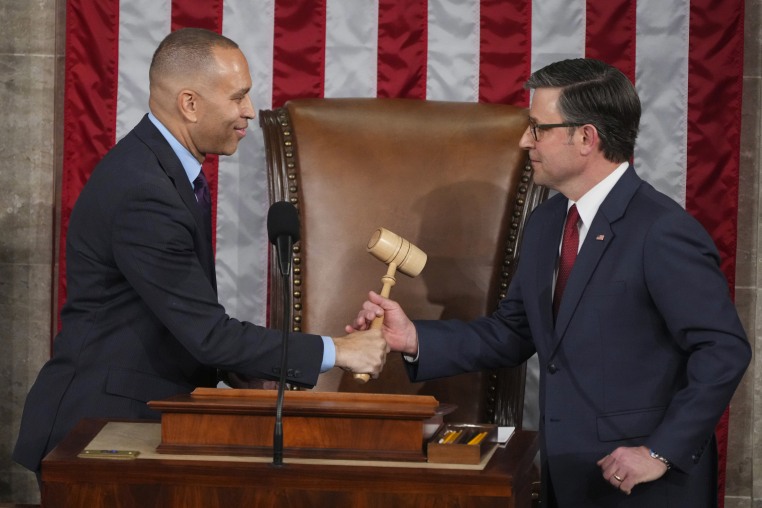 House Minority Leader Hakeem Jeffries, D-N.Y., left, hands the gavel to House Speaker Mike Johnson, R-La.