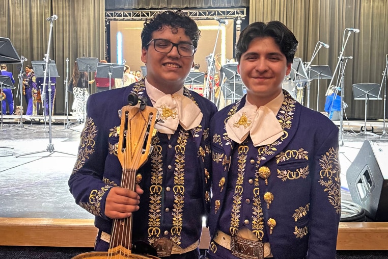 Antonio, third from left, and Caleb Gámez-Cuéllar, hold a trophy surrounded by their brother, mother and father.