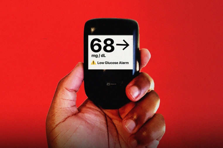 Hand holding glucose monitor that reads "68 mg/dL" 