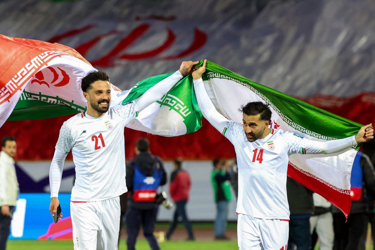 Iran's Omid Norafkan and Saman Ghoddos celebrate their victory in a World Cup qualifier against Uzbekistan on March 25, 2025 in Tehran.