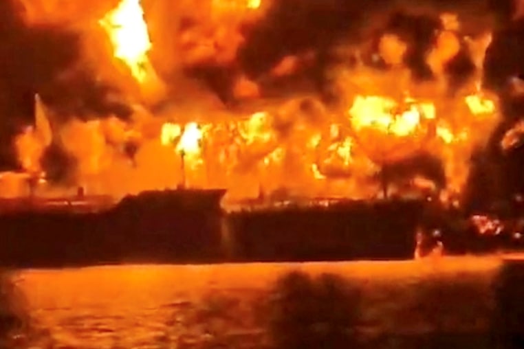 Image: A ship burns, after Iranian explosive-laden boats appear to have attacked two fuel tankers in Iraqi waters setting them ablaze