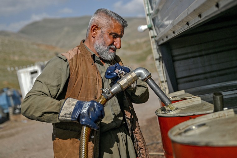 A vendor pumps petrol