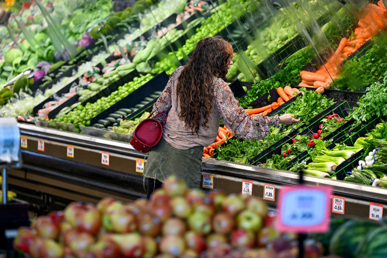 A customer shops produce.