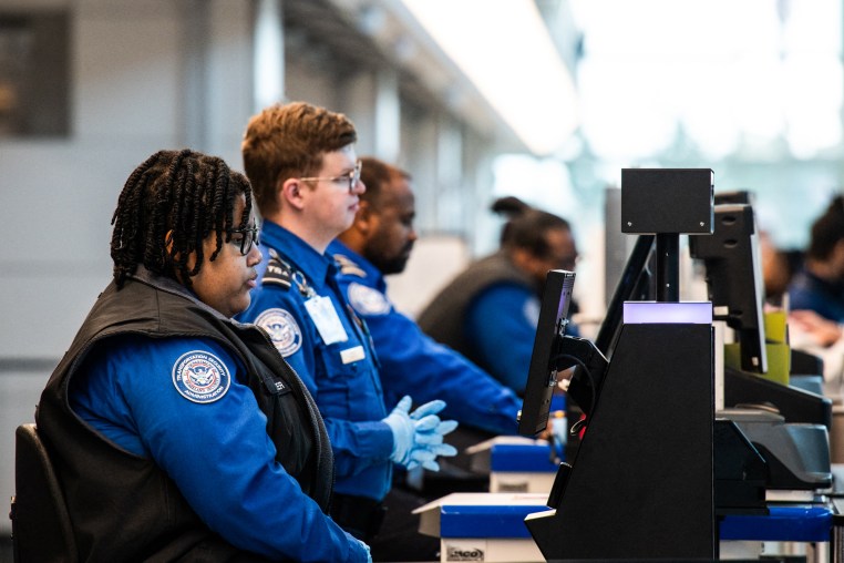 TSA agents seated at their stations