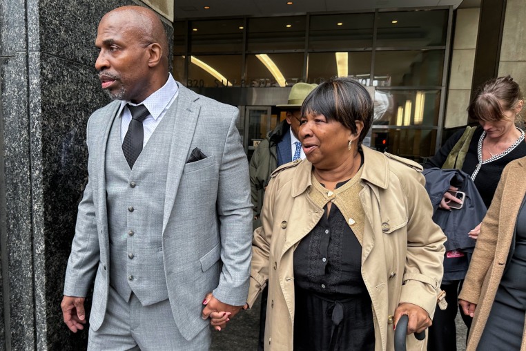 Kenneth Windley, left, leaves a courthouse with his mother, Francina Windley Patterson.