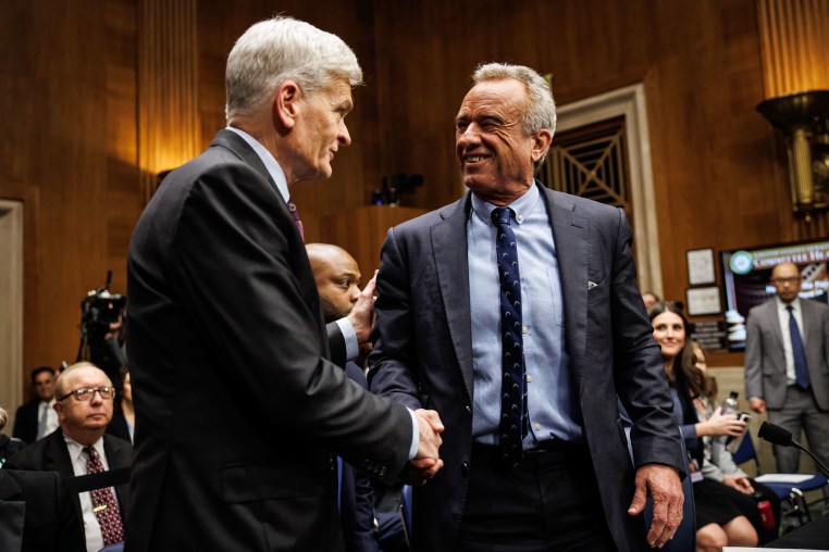 Secretary of Health and Human Services Robert F. Kennedy Jr. greets Sen. Bill Cassidy, R-La.,  as he arrives to testify on Capitol Hill on May 14, 2025.