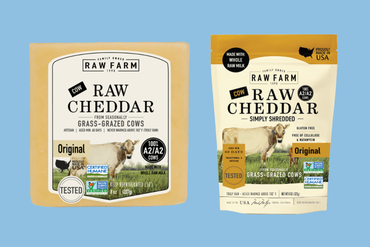 A photo illustration showing Raw Farm Raw Cheddar Cheese packaging and shredded cheese packaging next to one another on top of a blue background